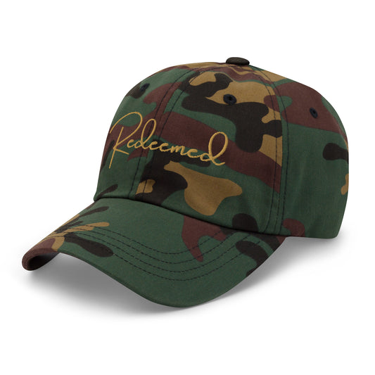 Right front angled view of camo “Redeemed” hat highlighting curved brim and embroidery.