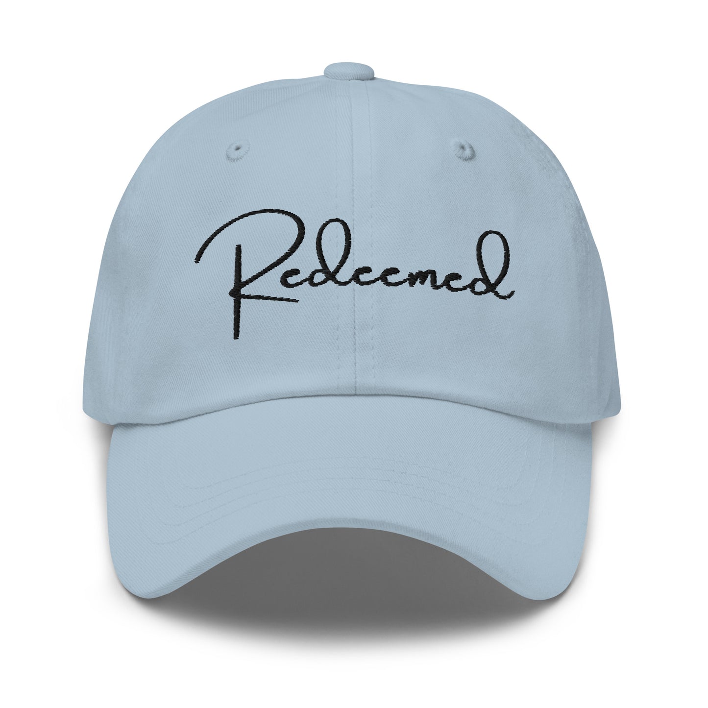 Front view of light blue dad hat with 'Redeemed' embroidered in black script