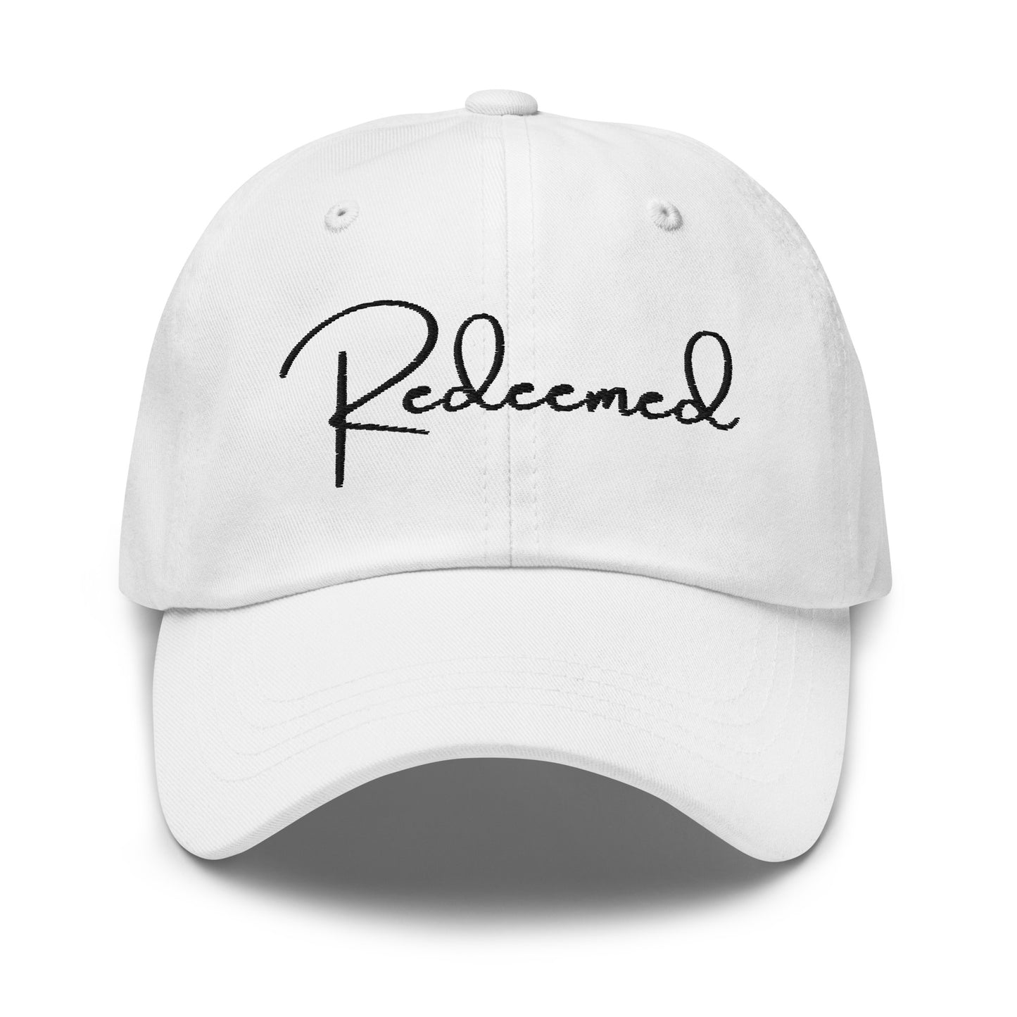 Front view of white dad hat with 'Redeemed' embroidered in black script