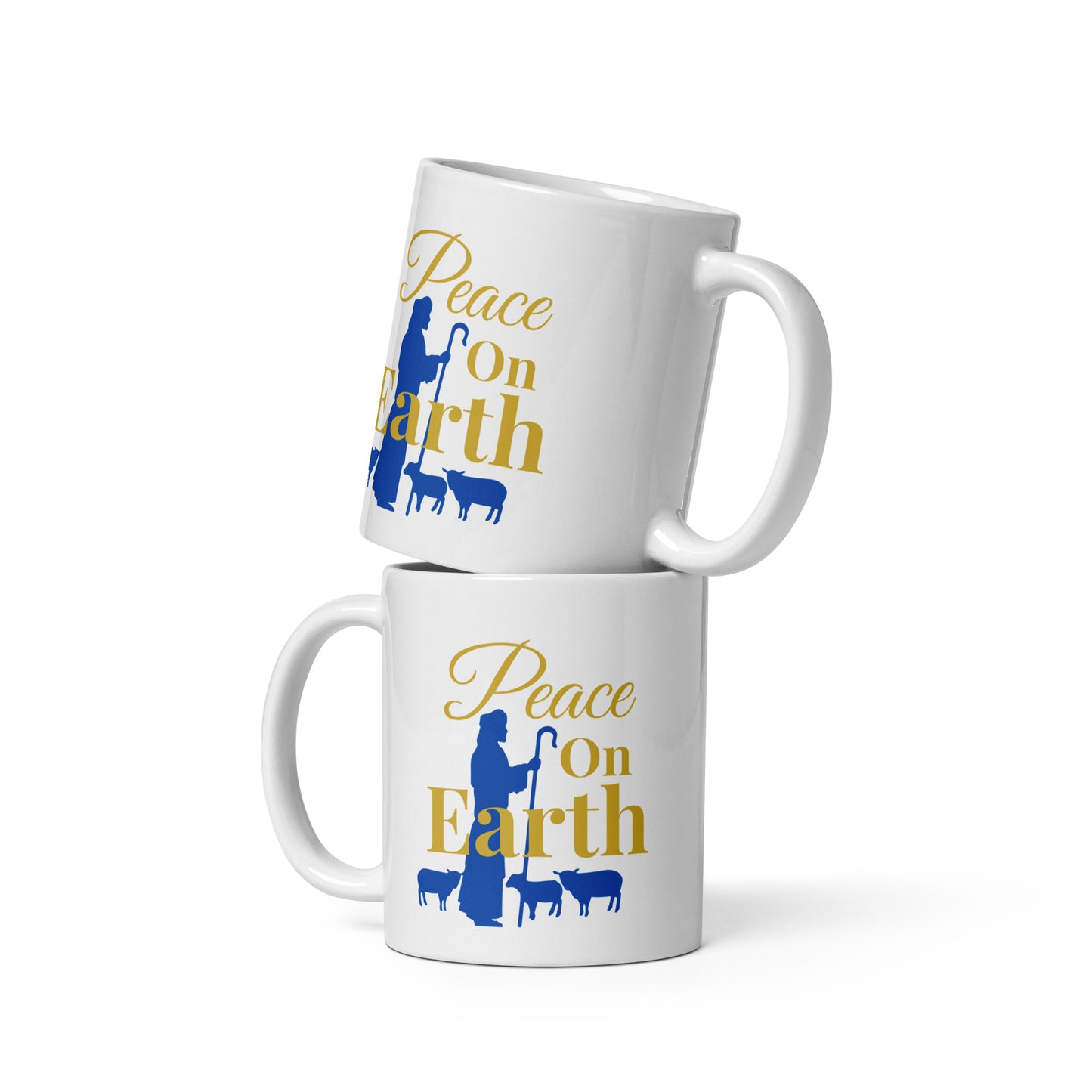 Stacked Peace on Earth Christmas mugs showing both left and right handle views with shepherd and sheep graphic