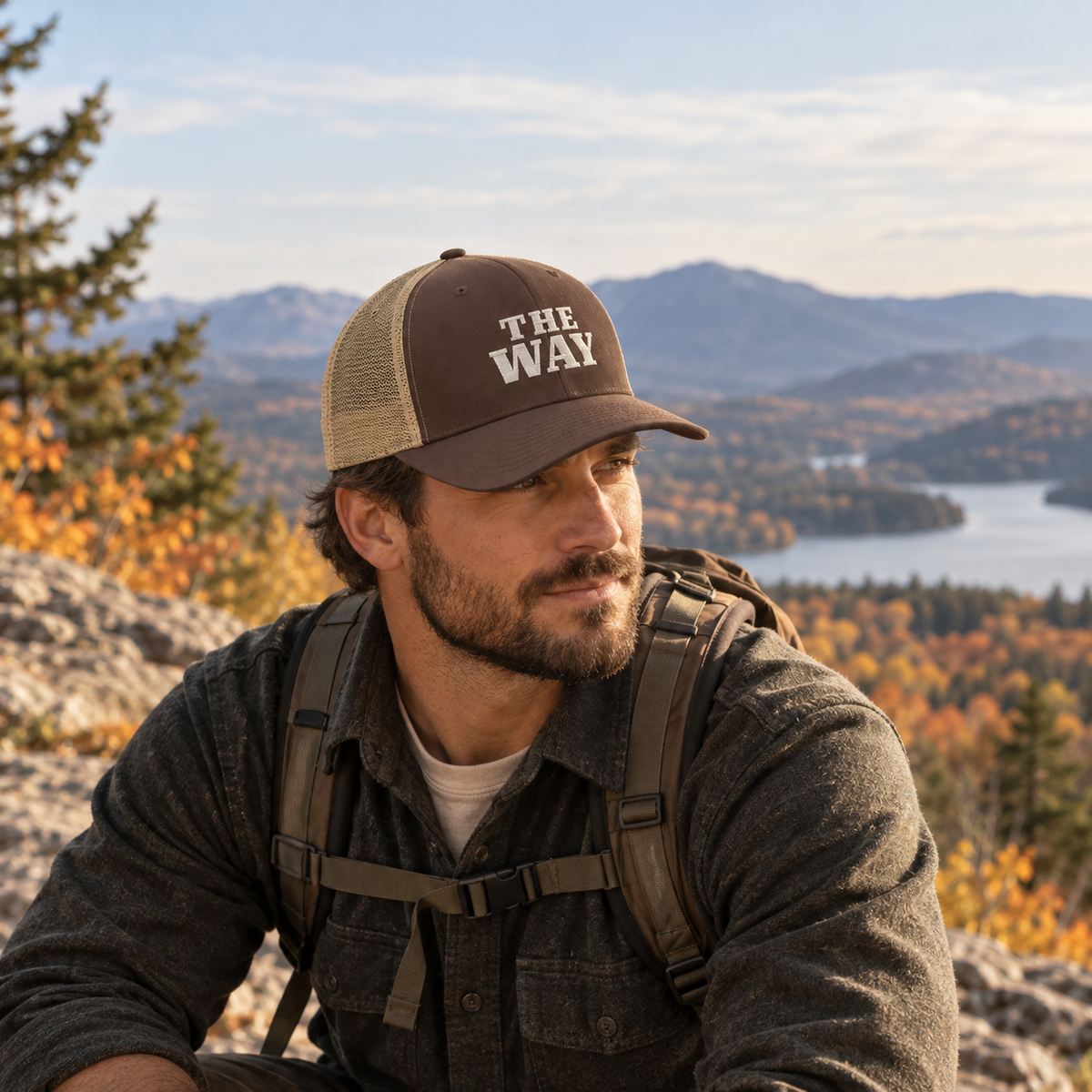 Man wearing The Way embroidered Christian trucker hat in brown and khaki during a fall hike