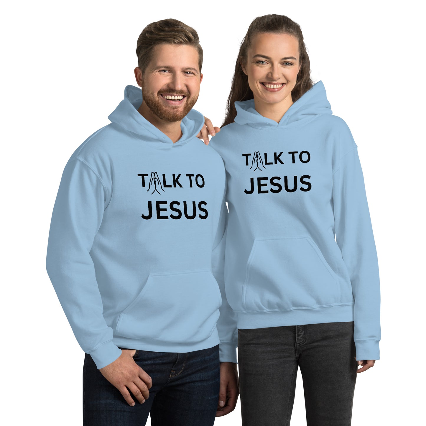 Couple wearing matching baby blue Talk to Jesus hoodies with black print; front design features praying hands replacing the letter A in “Talk.”