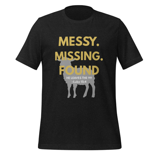 Front view of black heather Christian t-shirt with “Messy. Missing. Found.” printed in bold yellow over a lamb silhouette, with “He leaves the 99 – Luke 15:4” underneath