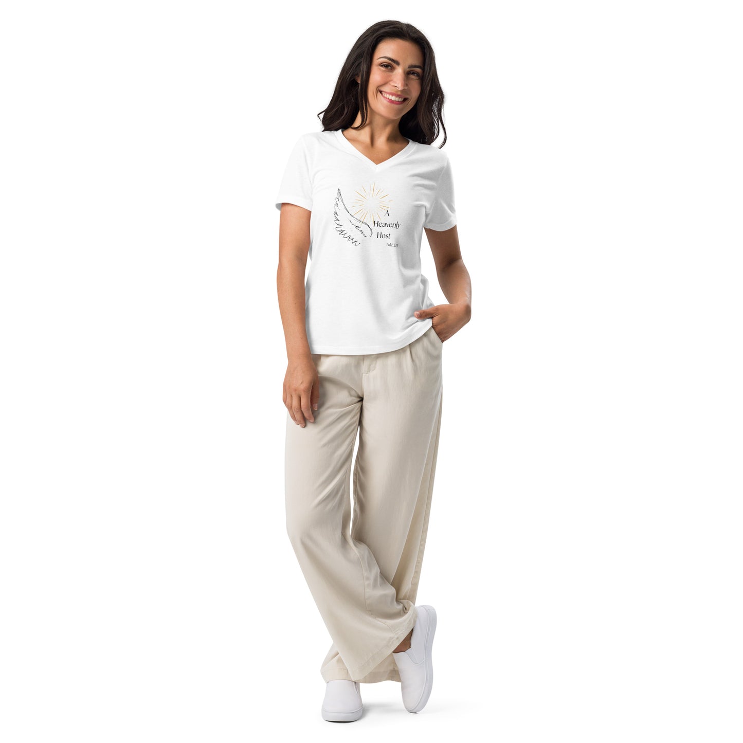 Full body lifestyle photo of woman in relaxed casual pants wearing Heavenly Host white V-neck Christmas shirt with angel wing and Luke 2:13