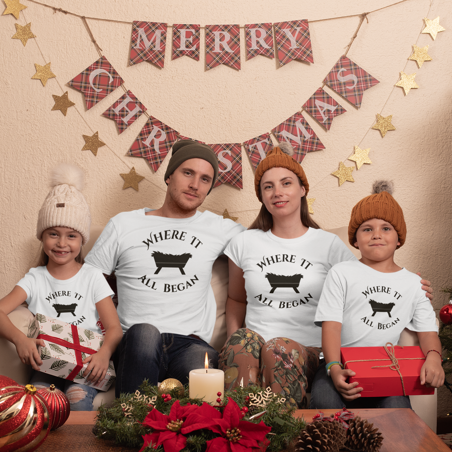 Family in Christmas setting wearing matching white “The Manger Story – Where It All Began” faith-based tees featuring manger design from Always Faithful