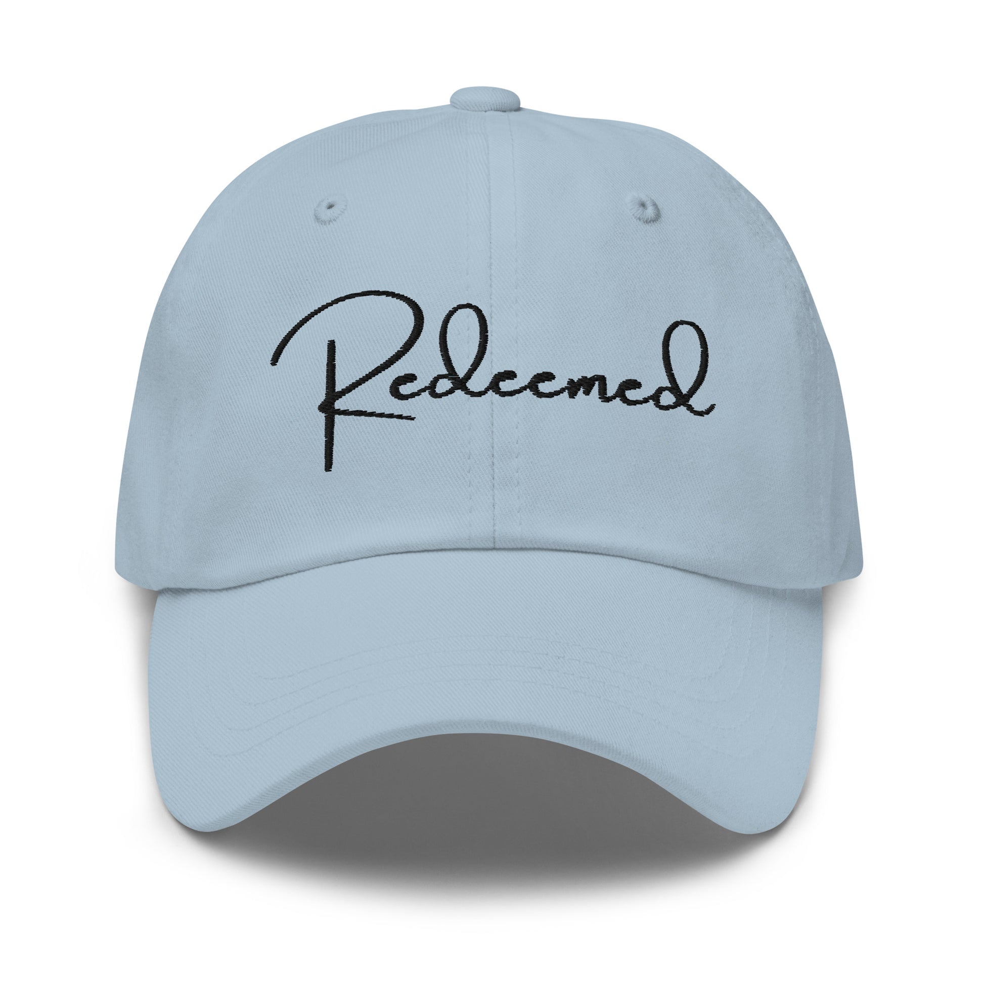 Front view of light blue dad hat with 'Redeemed' embroidered in black script
