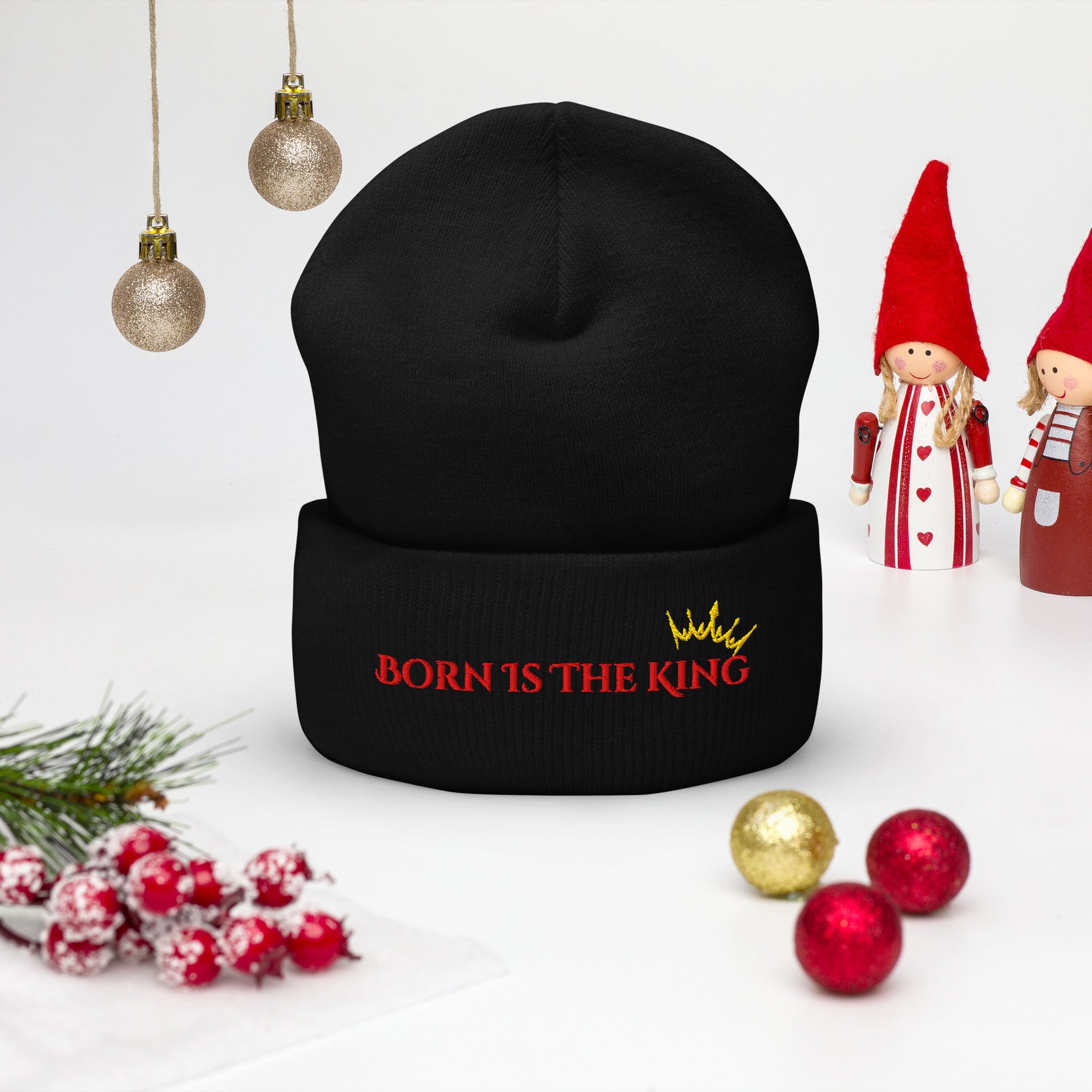 Front view of Born Is the King beanie in a Christmas scene with festive decor