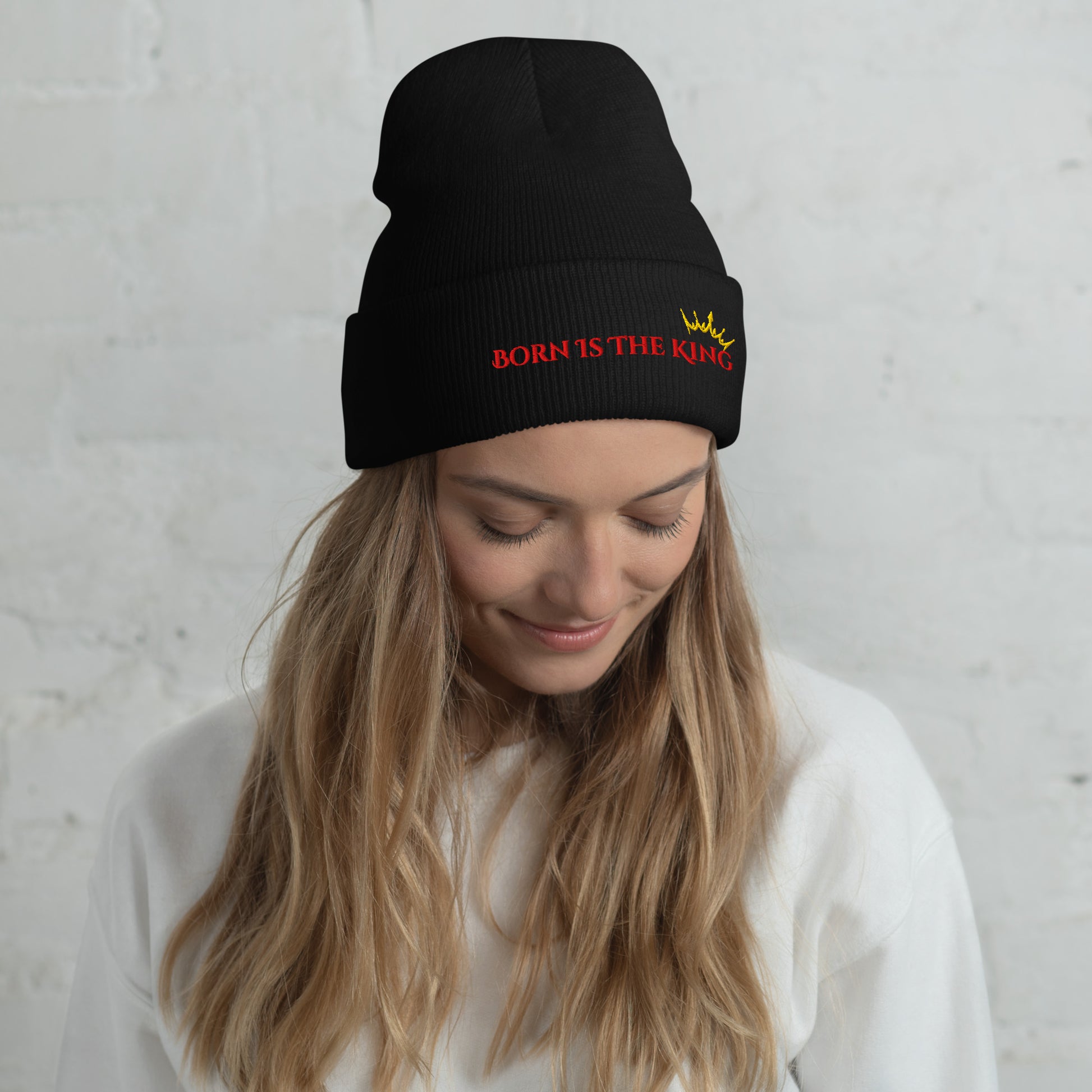 Female lifestyle image wearing Born Is the King black beanie