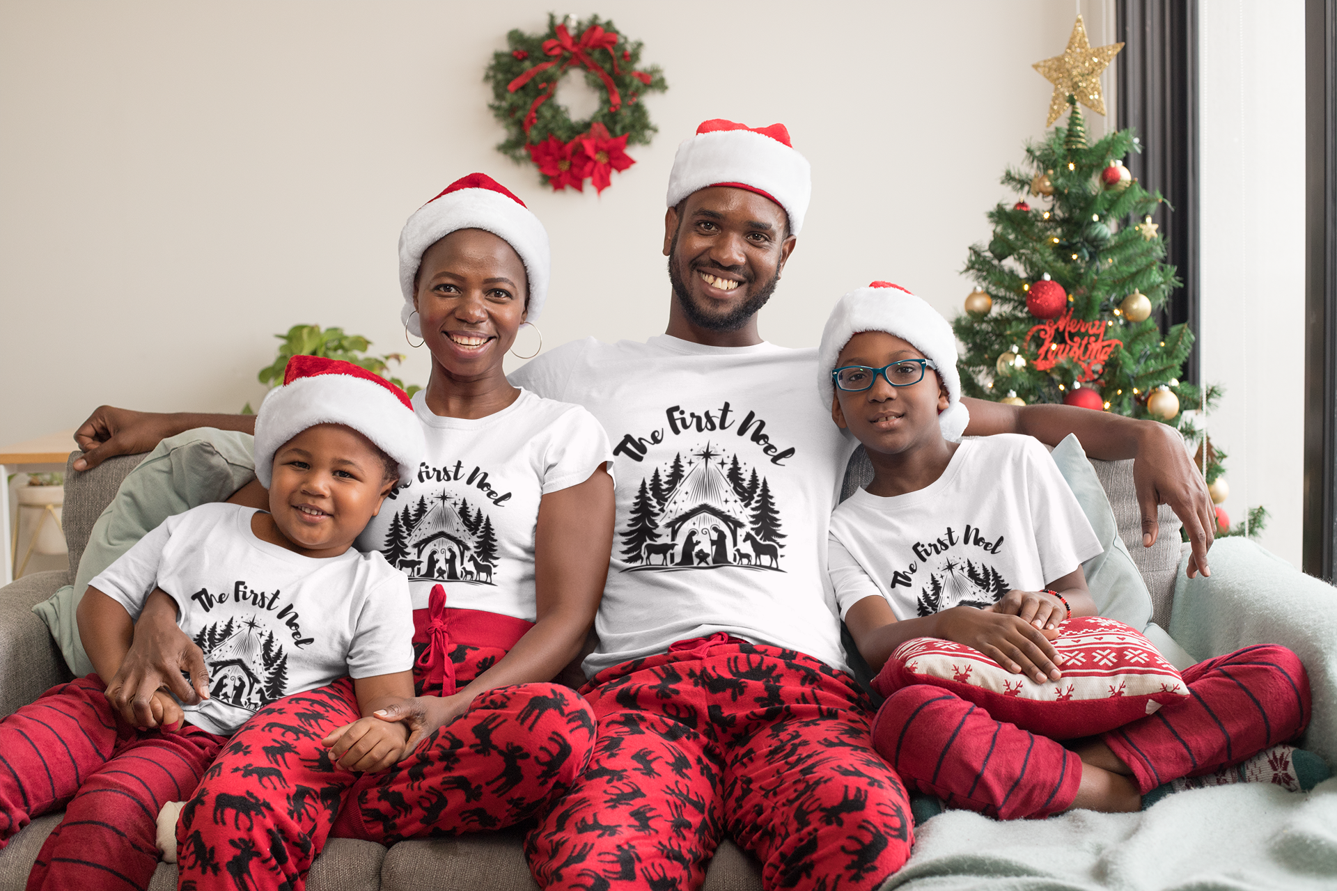 family wearing matching the first noel christmas shirts