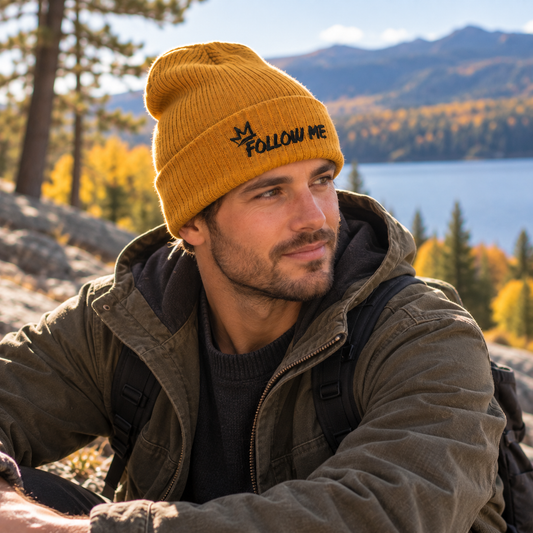 Man wearing the mustard Follow Me embroidered beanie in a nature setting
