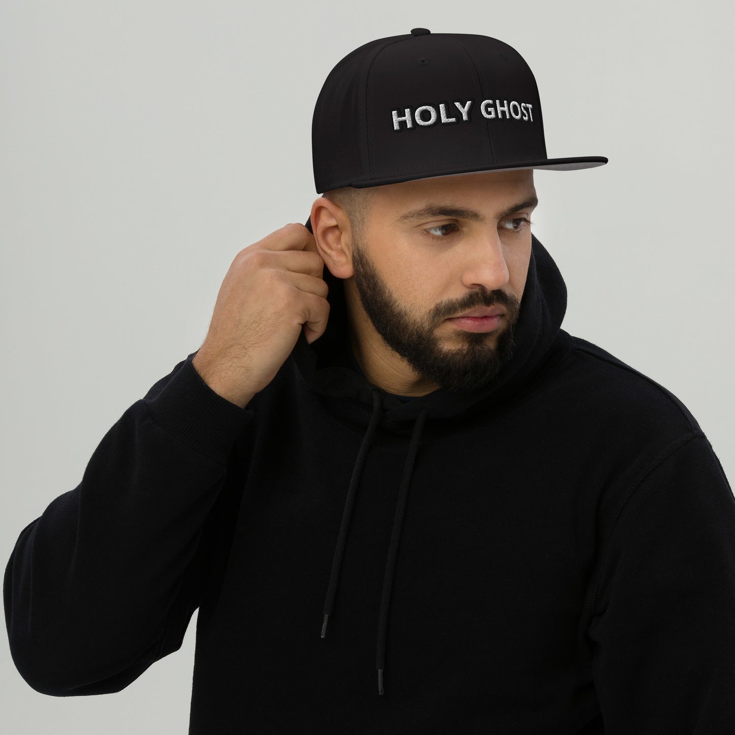 Lifestyle photo – male model wearing Holy Ghost snapback in urban streetwear setting