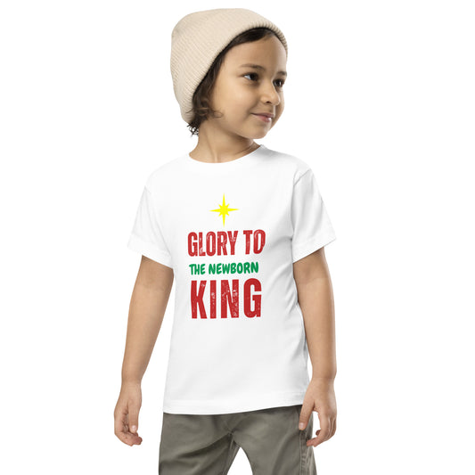 Toddler wearing Glory to the Newborn King Christmas Tee with cranberry and green lettering and star above – Christian Christmas shirt by Always Faithful.
