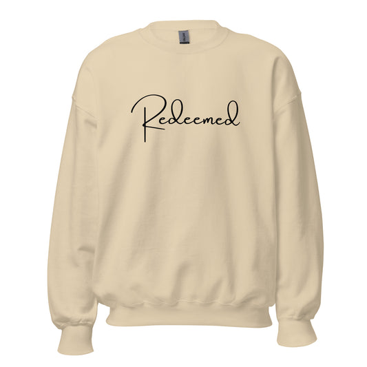 Front view of the Redeemed crewneck sweatshirt in Sand with bold black printed text across the chest.