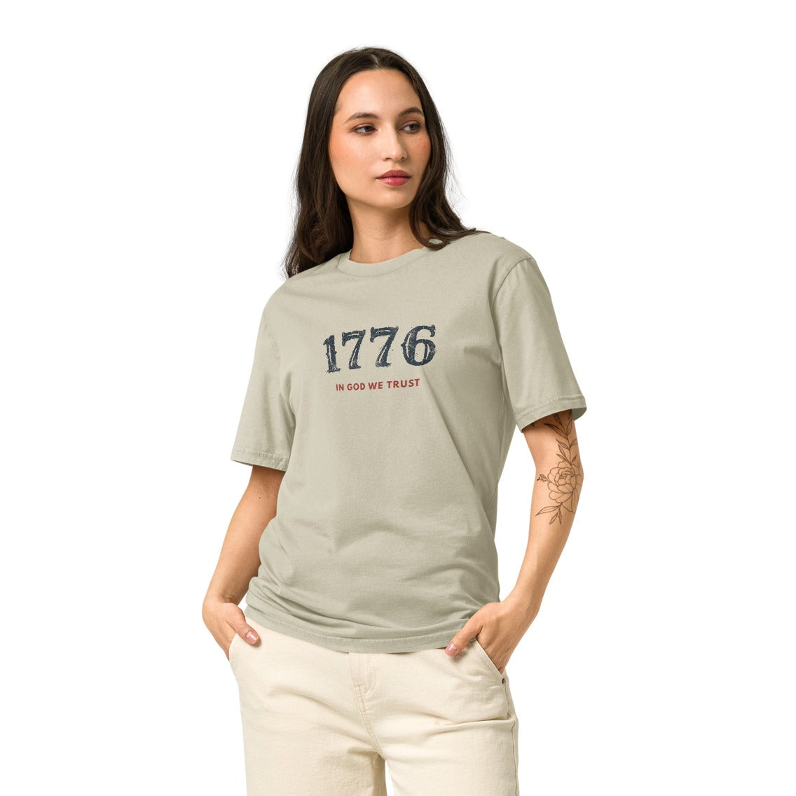 Woman modeling the USA 1776 Christian Tee in Dyed Stone featuring the 1776 and In God We Trust front design.