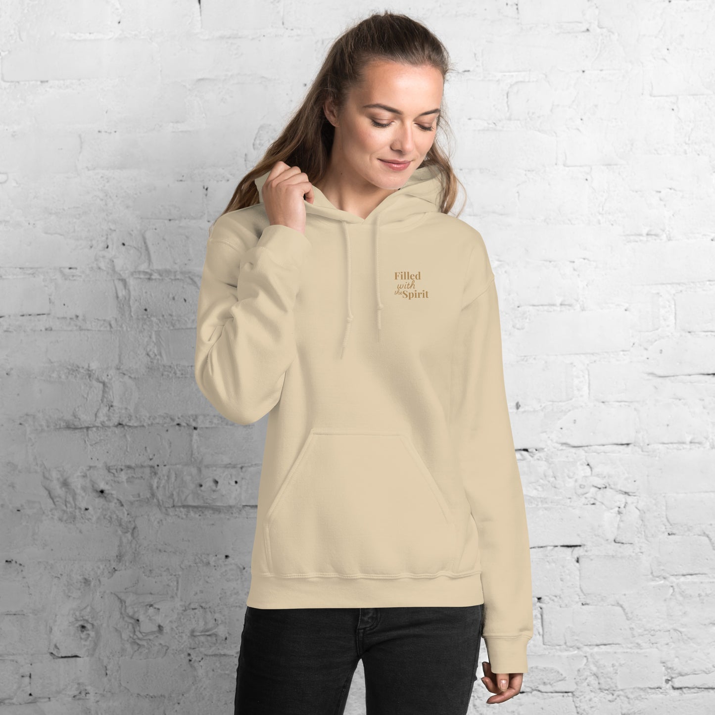 Female model wearing sand-colored Holy Spirit hoodie, front view with “Filled with the Spirit” text on chest – Christian praise and worship apparel
