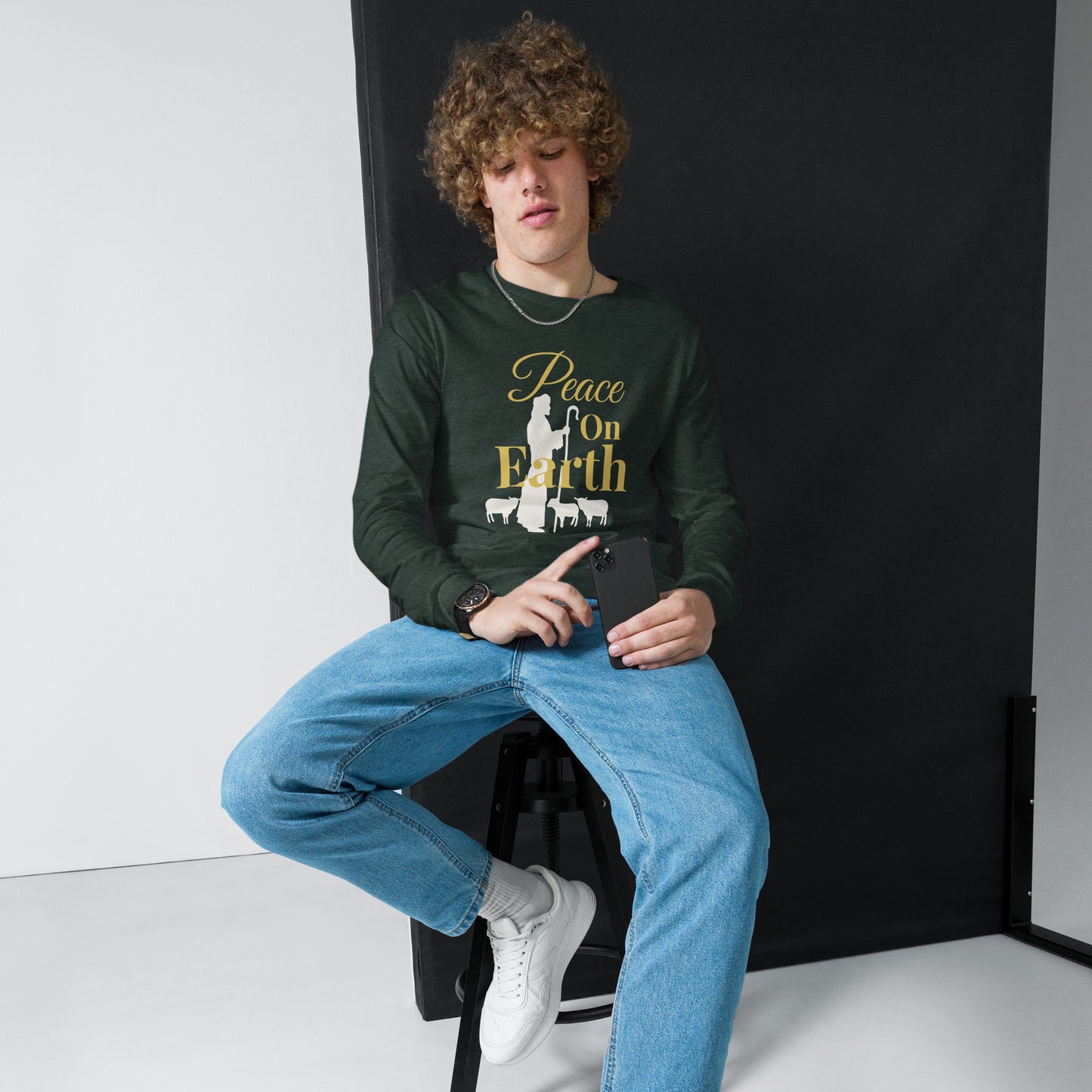 Man wearing heather forest Peace on Earth long sleeve Christmas shirt with shepherd and sheep graphic – Luke 2:14
