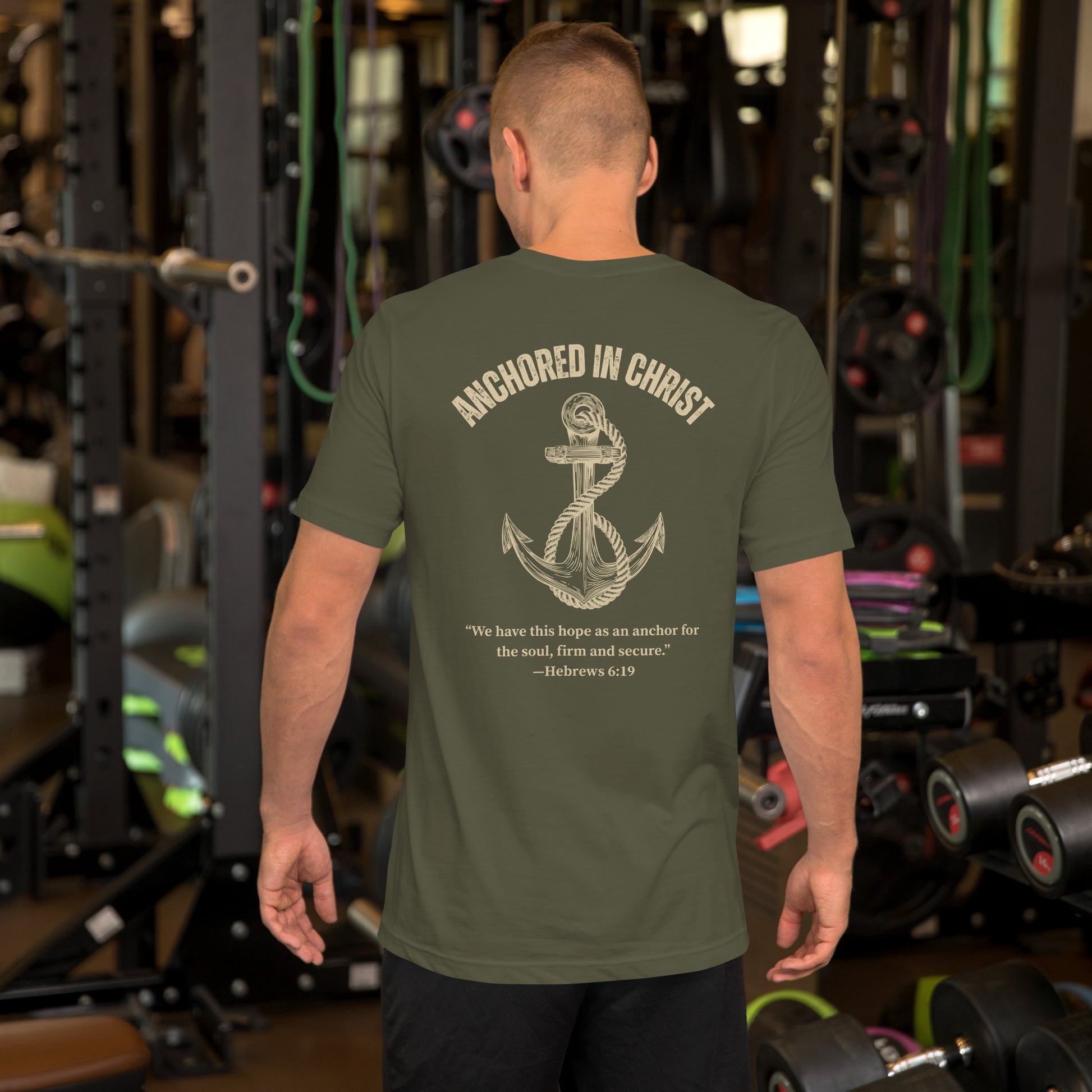 Man wearing Anchored in Christ Field Edition shirt, back view in military green