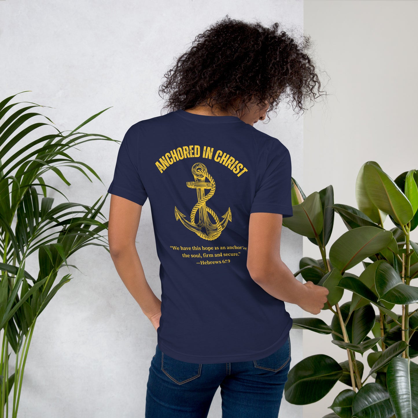 Female model lifestyle photo, back view wearing the Anchored in Christ – Deep Waters Edition tee.