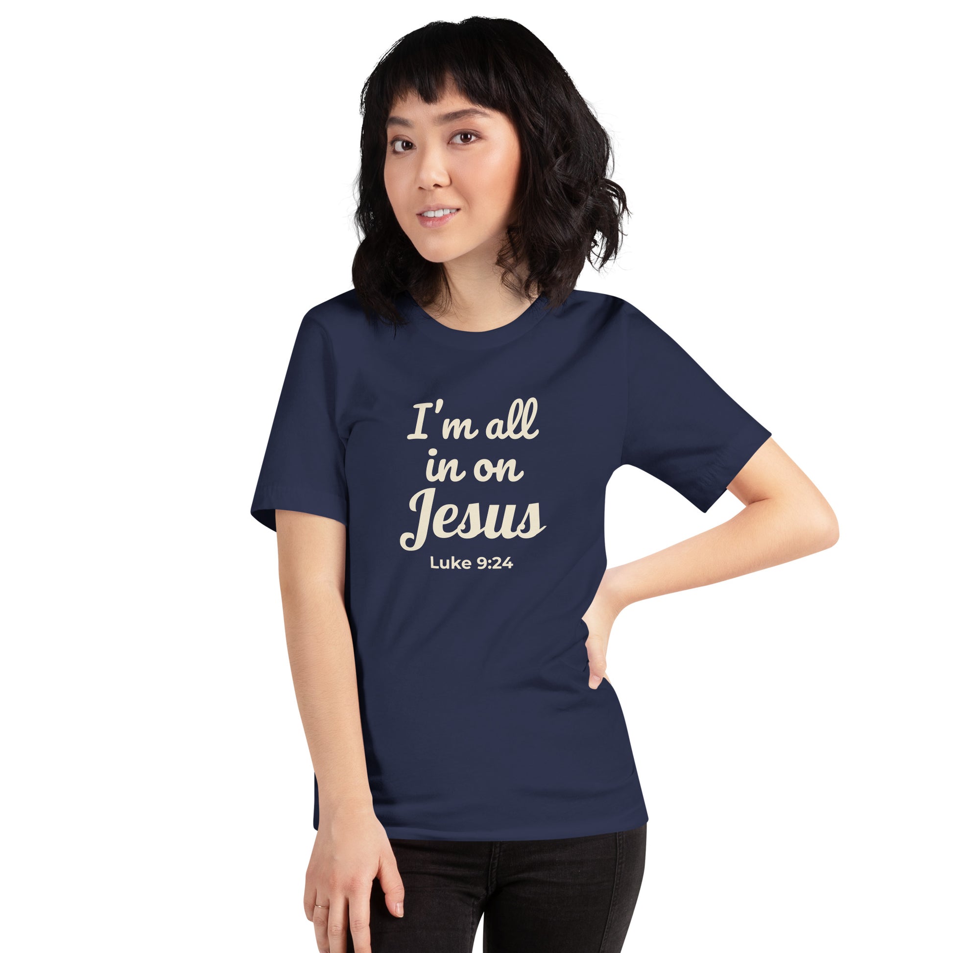 Female model wearing navy “I’m All In on Jesus” tee, facing forward to show cream-colored design and scripture from Luke 9:24

