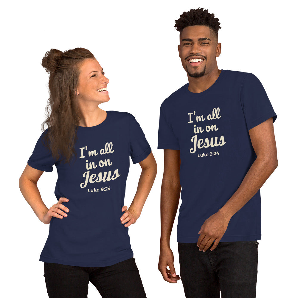 Happy couple wearing matching navy blue “I’m All In on Jesus” tees, smiling and standing outdoors, showing bold faith-based front design
