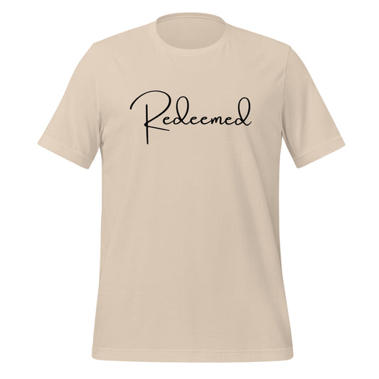Front view of Redeemed T-shirt in soft cream with bold black script and supporting Bible verse.

