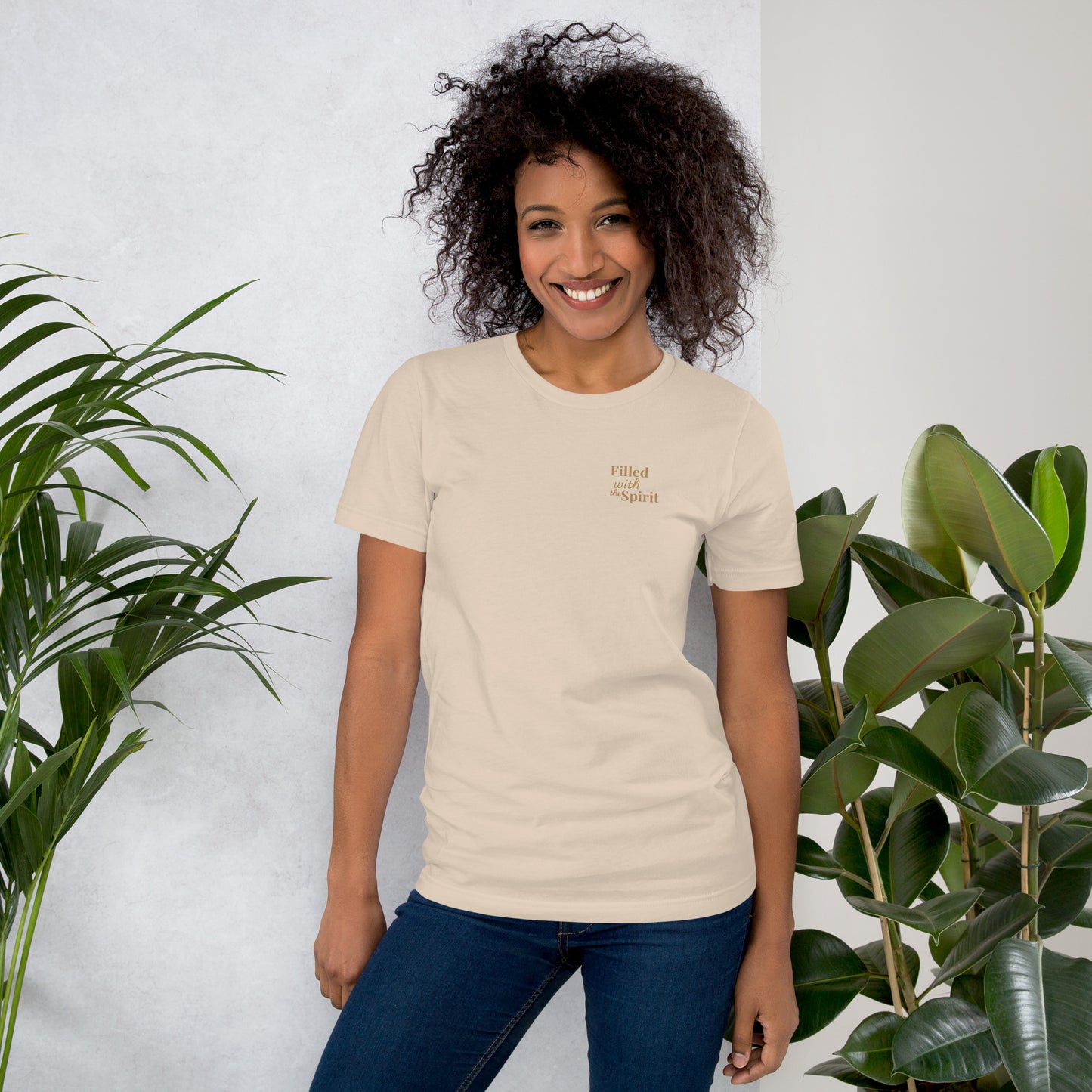 Female model wearing cream-colored Holy Spirit t-shirt, front view with “Filled with the Spirit” text – Christian praise and worship clothing
