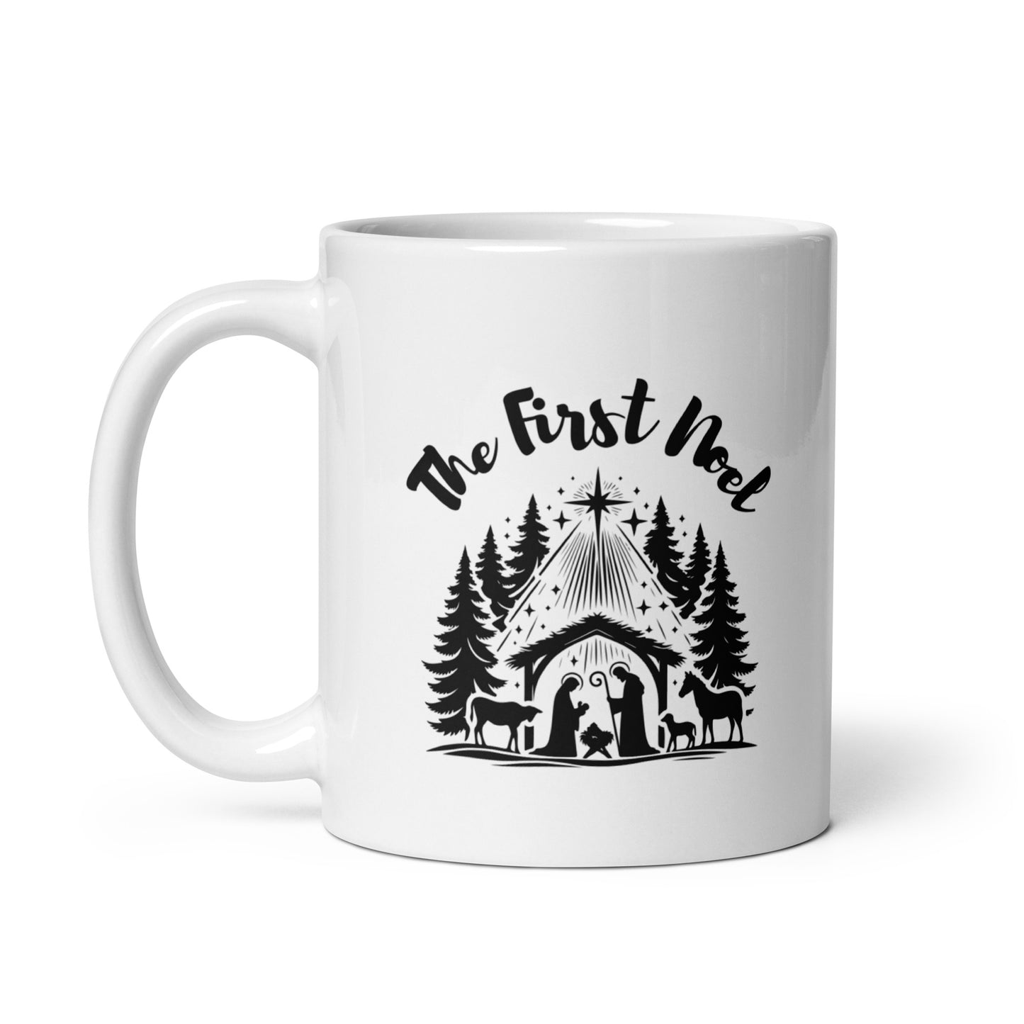 Front view of 11 oz white ceramic mug with black nativity design and “The First Noel” text; handle is on the left side.
