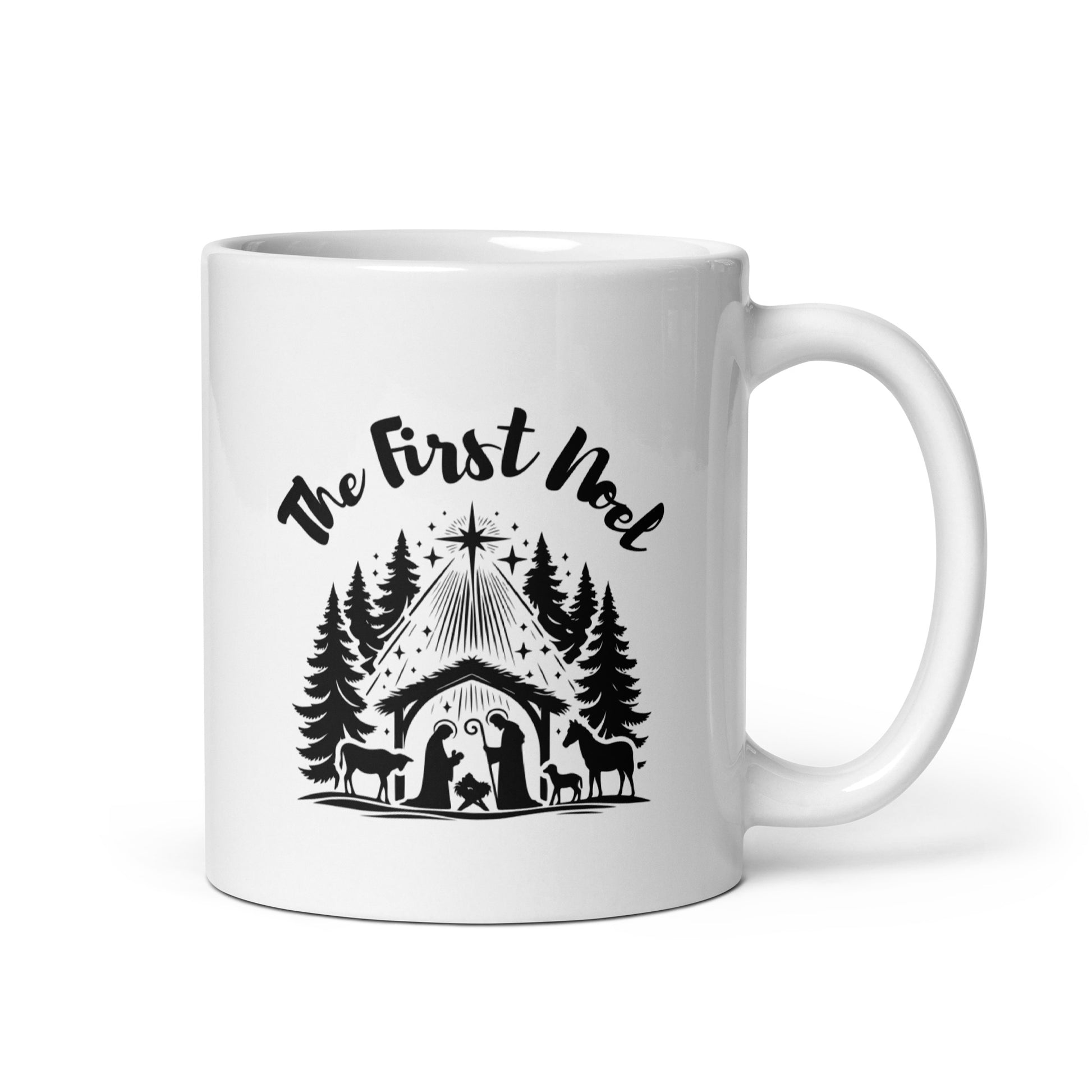 11 oz white ceramic mug with The First Noel and nativity design printed in black on both sides, featuring a manger, Christmas star, and pine trees.
