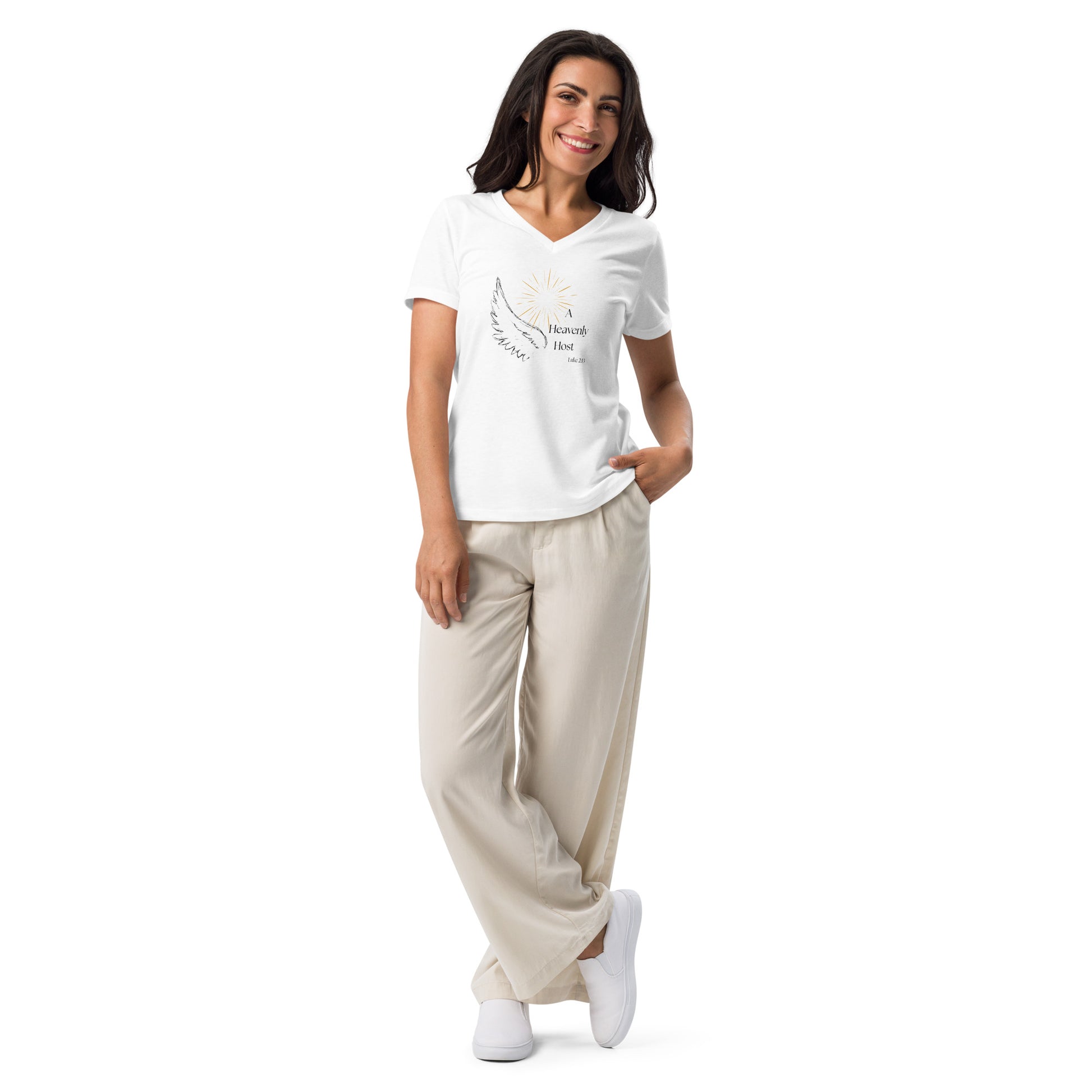 Full body lifestyle photo of woman in relaxed casual pants wearing Heavenly Host white V-neck Christmas shirt with angel wing and Luke 2:13
