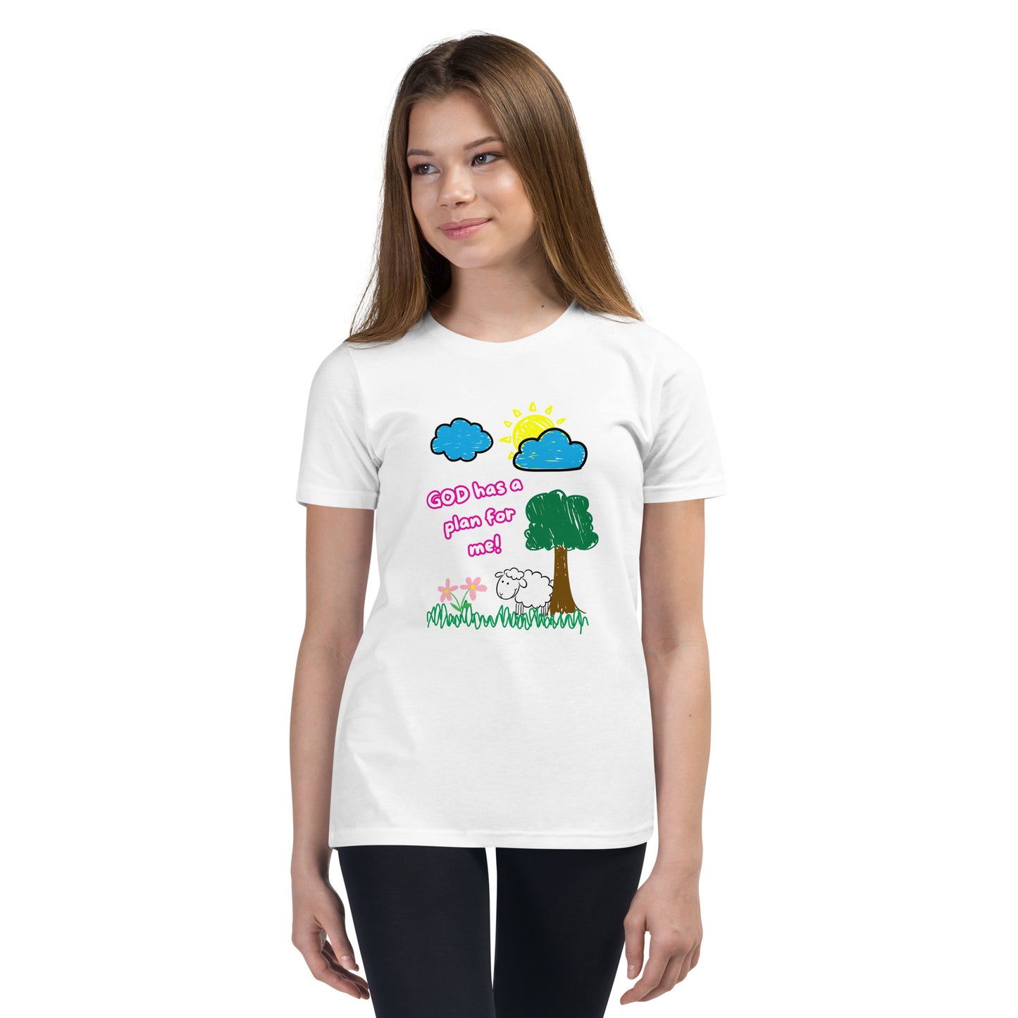 Girl wearing youth girl’s Christian shirt with pink text “God Has a Plan for Me” and a graphic of a sheep in grass with flowers, tree, sun, and clouds
