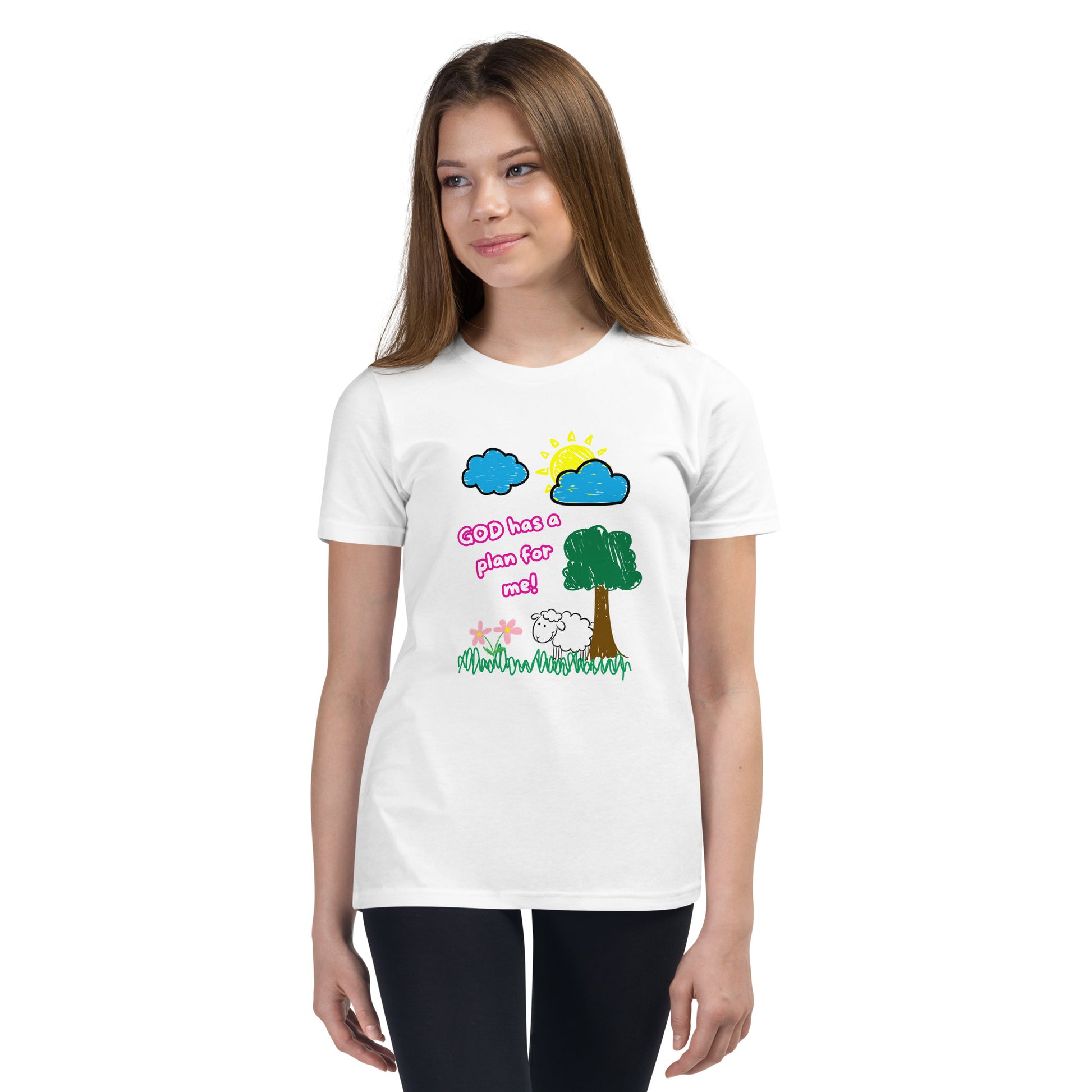 Girl wearing youth girl’s Christian shirt with pink text “God Has a Plan for Me” and a graphic of a sheep in grass with flowers, tree, sun, and clouds
