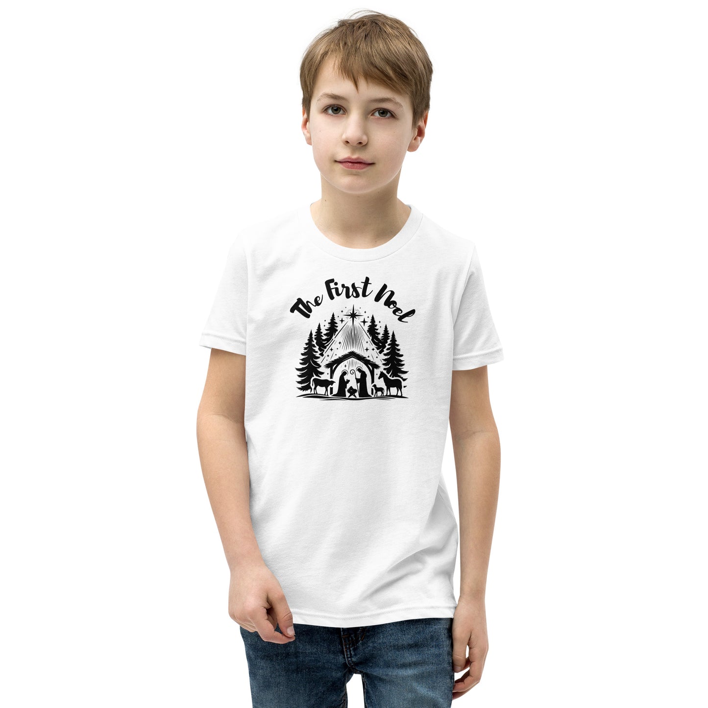 Youth white Christian Christmas tee with black nativity design and The First Noel text inspired by Luke 2:11.
