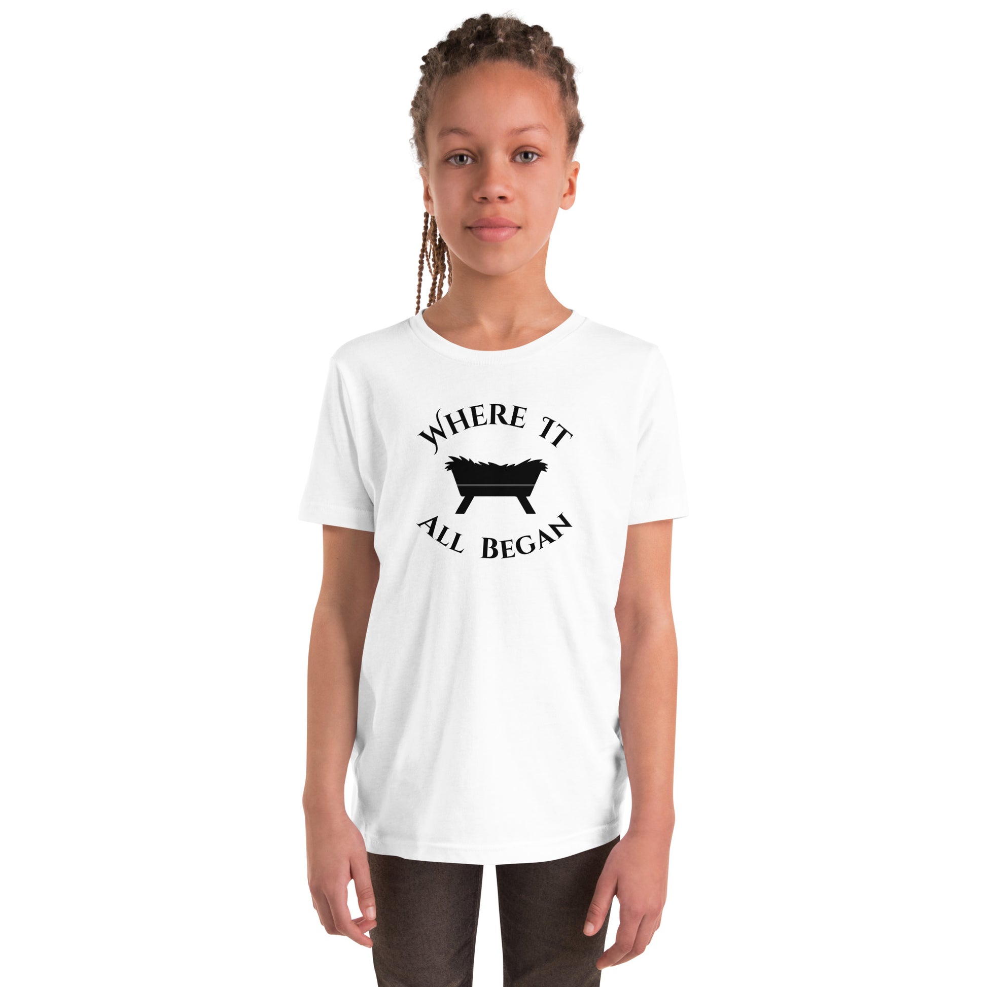 Youth model wearing white “The Manger Story – Where It All Began” Christmas tee with manger design printed in black